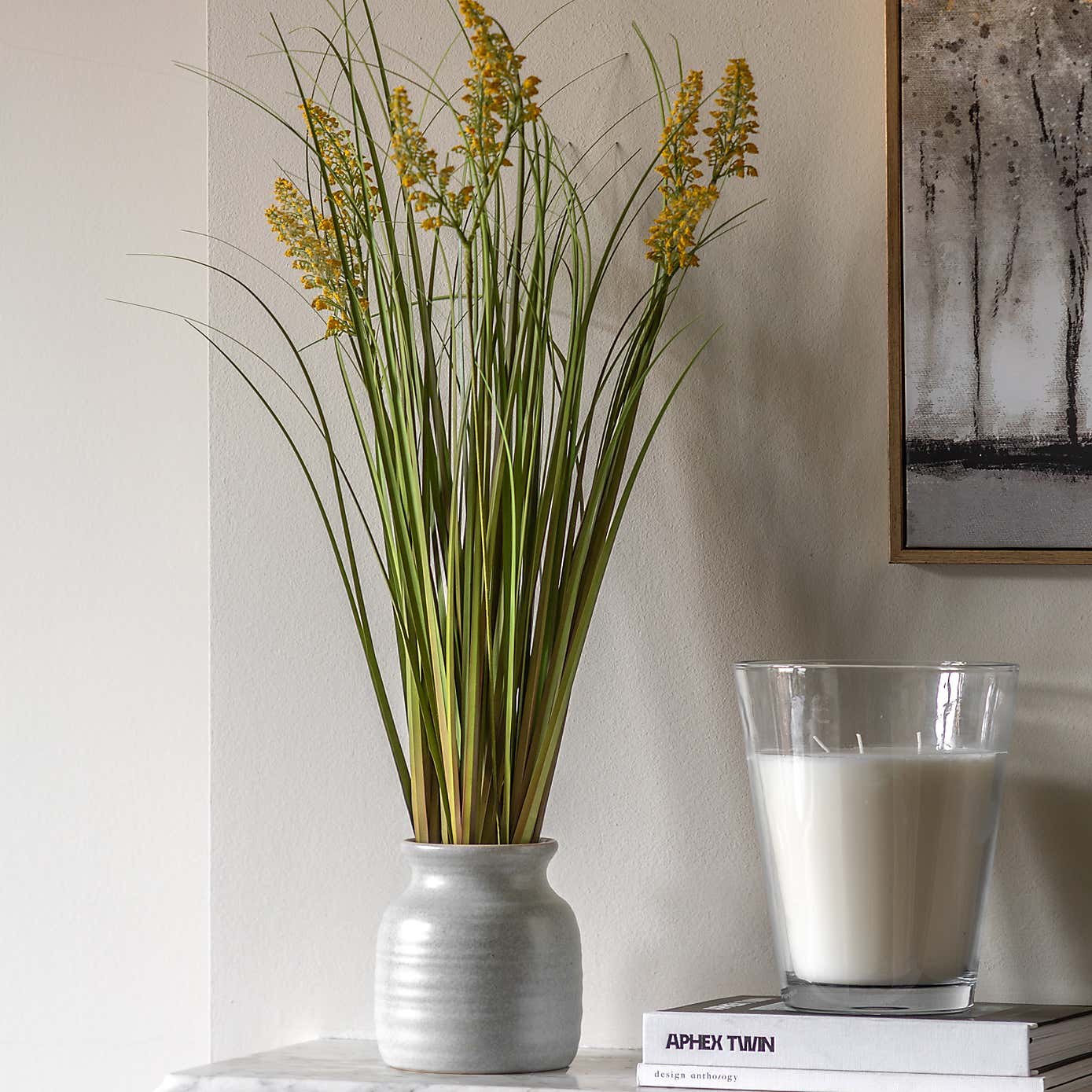 Artificial Grass with Yellow Wildflower in Black Plant Pot